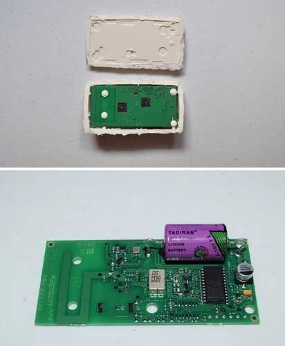 Upper, E-ZPass with bottom cut off, exposing underside of green PCB board. Lower, top of PCB with large, cylindrical, purple lithium battery.