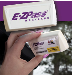 Hand placing an E-ZPass transponder on a windshield.